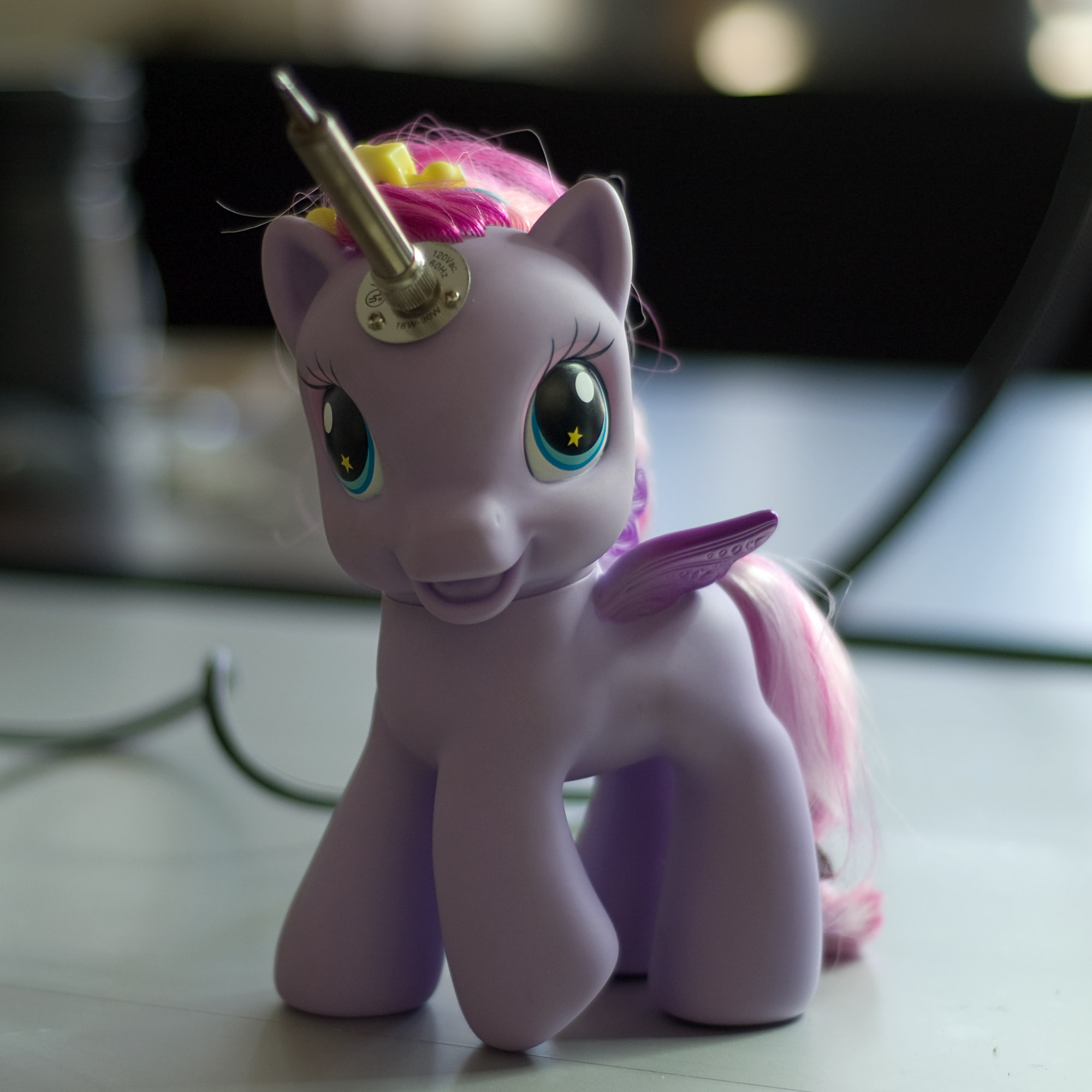 Child's play pony with a soldering iron horn