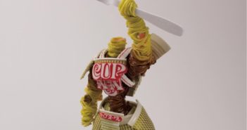Tuesday Sweep: 18 September 2018 a tangle of noodles in the shape or a warrior wielding a fork overhead in defiance. Armor is made from cup-of-noddles packaging.