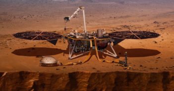 Tuesday Sweep: 27 November 2018 Mechanical bird dinosaur with solar panel wings perched on a red dusty cliff.