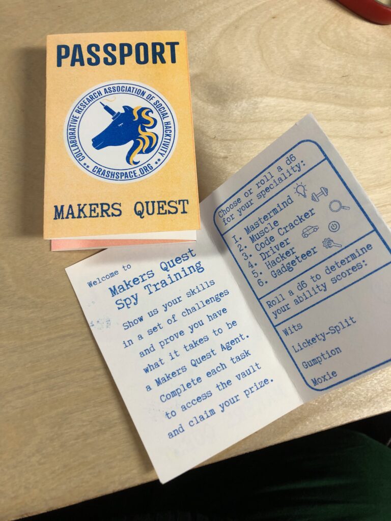A folded piece of paper with "Passport Makers Quest" printed on it