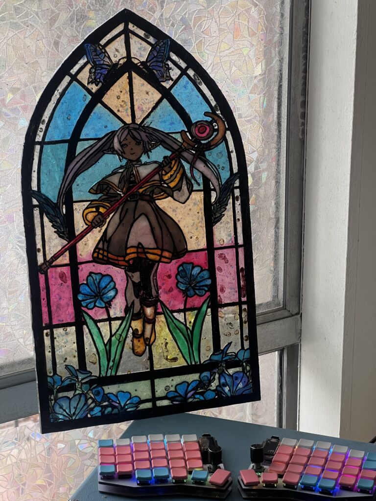 finished laser cut stained glass project shown against a window from up close