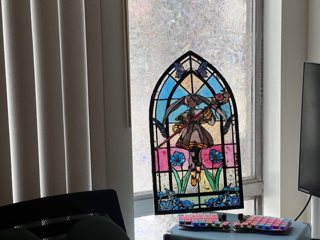 finished laser cut stained glass project shown against a window from a distance